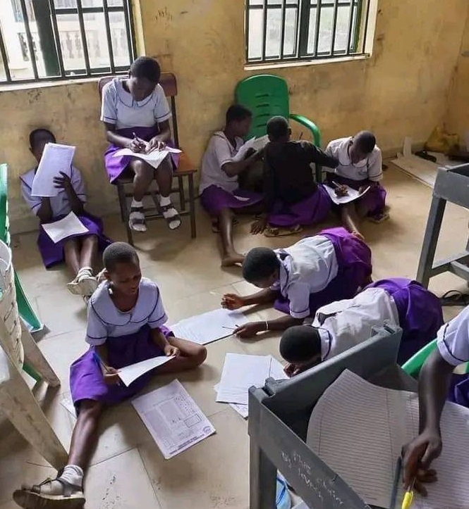 Secondary school students sitting on bare floor to lean in Bayelsa state